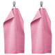 Two pink VÅGSJÖN towels hang side by side on metal hooks, featuring a soft textured design and vibrant colour.