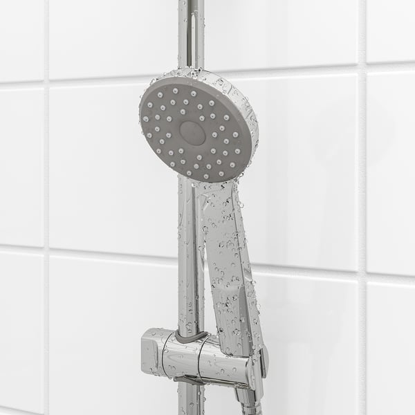 Shower with wide spray head, adjustable bracket, and water-saving washer.