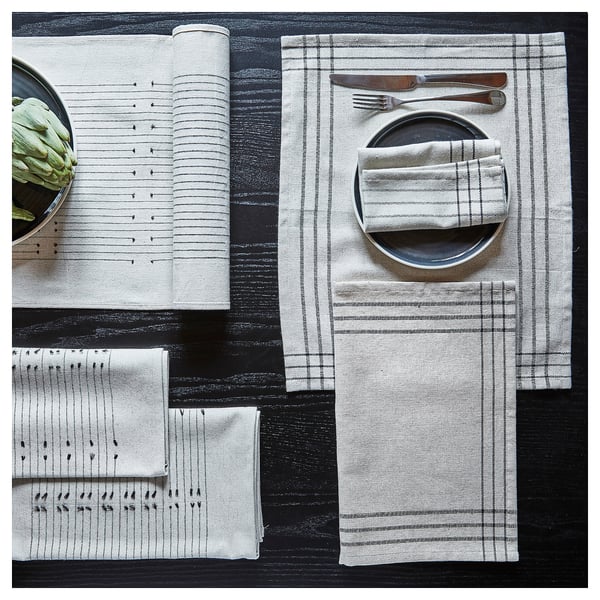 VÅRARV place mats in earthy tones, made of cotton and jute, featuring subtle patterns. Square shape, set neatly together.