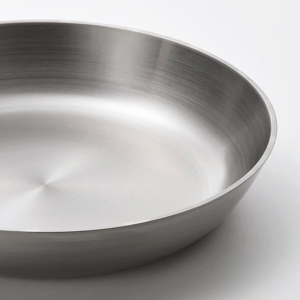 Shiny, sleek stainless steel bowl; high-quality, smooth finish; reflects light beautifully.