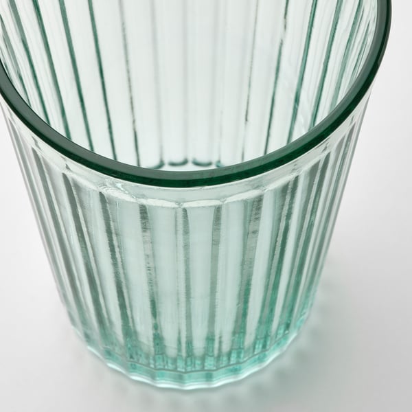 Sturdy, clear glass cup with vertical ridges, designed for durability and elegance.