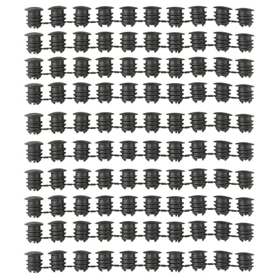 Image multiple rows of black VARIERA cabinet hole covers, displaying their cylindrical shape and ribbed design made of polyethylene plastic.