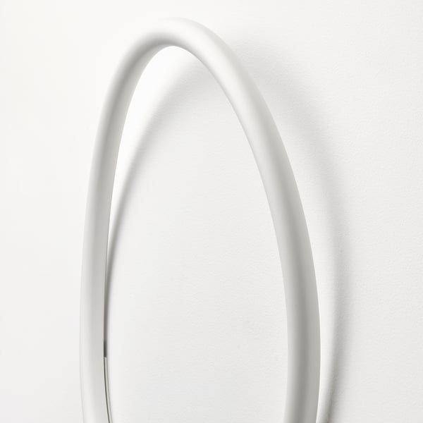 Elegant round wall lamp, emitting soft glow, with sleek white finish.