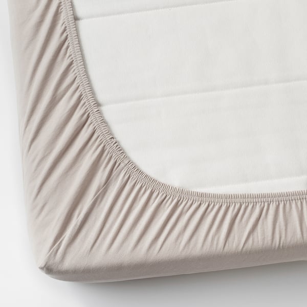 A fitted sheet with elastic corners made of soft, stretchy cotton jersey for a snug fit.