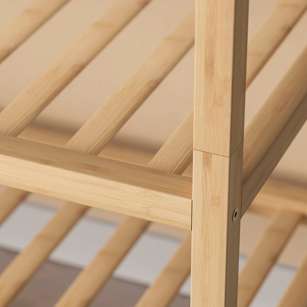 Close-up of a shoe rack made of polished bamboo with a natural finish, showcasing its clean joints and sturdy construction.