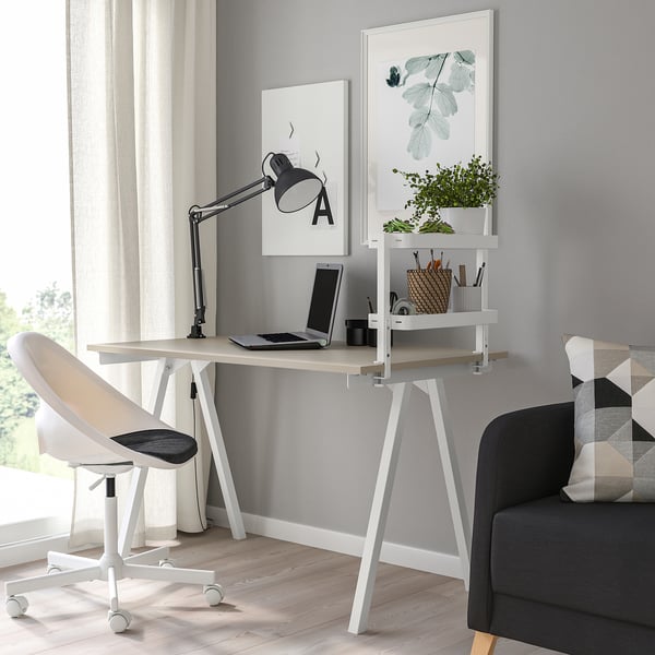 Minimalist home office: VATTENKAR wall shelf with plants, desk, lamp, chair, and sofa.