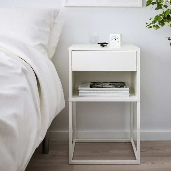 White VIKHAMMER bedside table with drawer and magazine shelf.