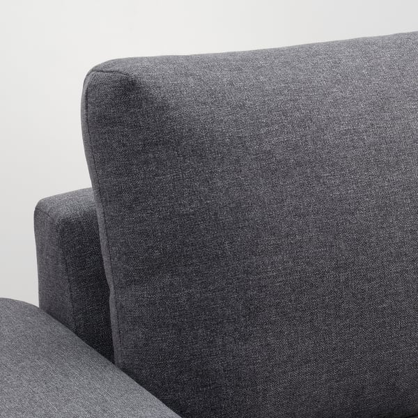 Grey sofa close-up: soft, durable fabric with minimalist design. Clean lines, comfortable cushions.
