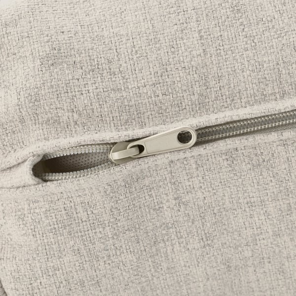 Close-up of a beige zip on a textured fabric couch, highlighting smooth zip pull and robust stitching.