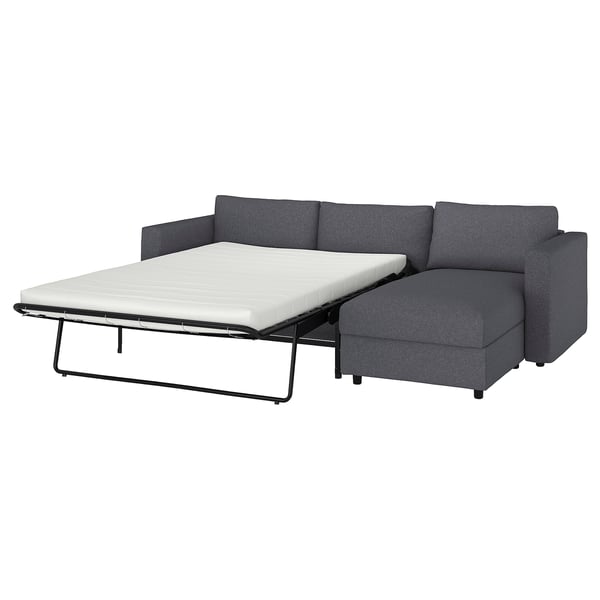 Modern charcoal sofa-bed with chaise, clean lines & removable cushions for comfort & easy storage.