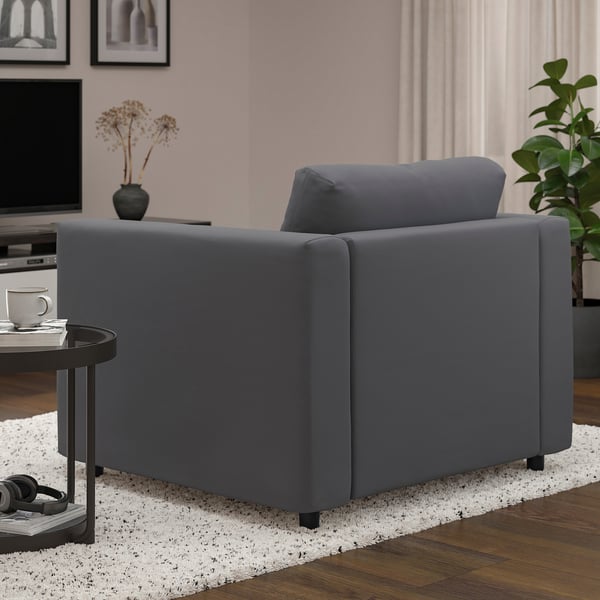 Grey VIMLE chair in modern living room, beside small table with cup.