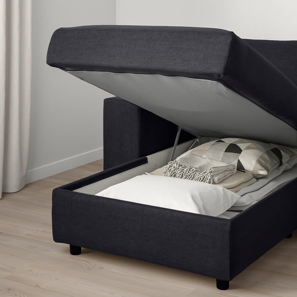 Modern bed with corduroy upholstery, open storage compartment under raised headrest.