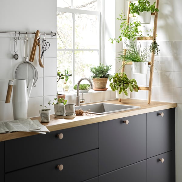 Modern kitchen with grey cabinets and wooden countertop, VINNÄSET knobs.