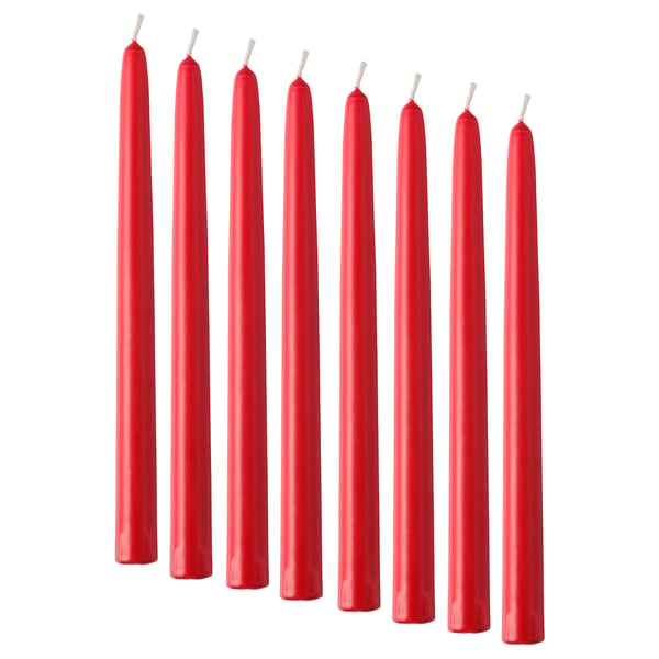 Eight straight red candles lined up, unlit, pure stearin material.