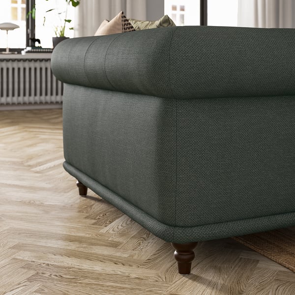 Green VISKAFORS armchair with round shapes and soft seat; cotton, polyester, viscose blend; sturdy dark wooden legs.