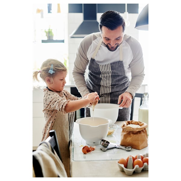 Person and girl wearing aprons collaborate in kitchen using VISPAD bowls.
