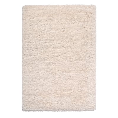 A beige, rectangular, shaggy rug with varied texture, made of recycled polyester and polypropylene.
