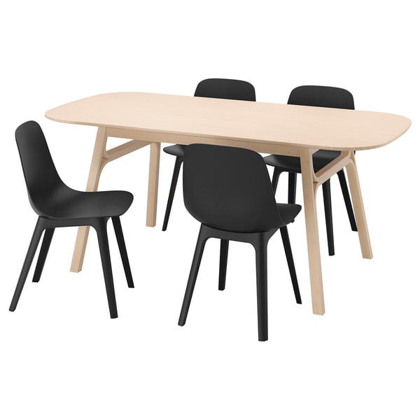 A voxlov dining set with a light brown wooden table and four black chairs, designed for easy assembly and comfort.