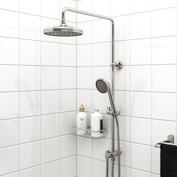 VOXNAN shower kit in chrome: hand/head sprayer, tiled wall, glass shelf, black towel.