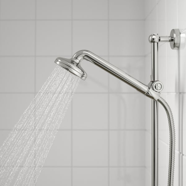 A chrome shower head with a full spray function in action, mounted on a adjustable arm, with water flowing down.