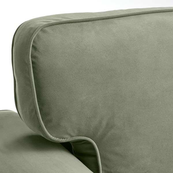 Close-up of VRETSTORP sofas cushioned corner, showcasing soft, green fabric and quality stitching.