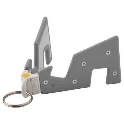 Grey plastic mobile phone holder with a key ring attachment, designed by IKEA, compact and foldable for travel convenience.