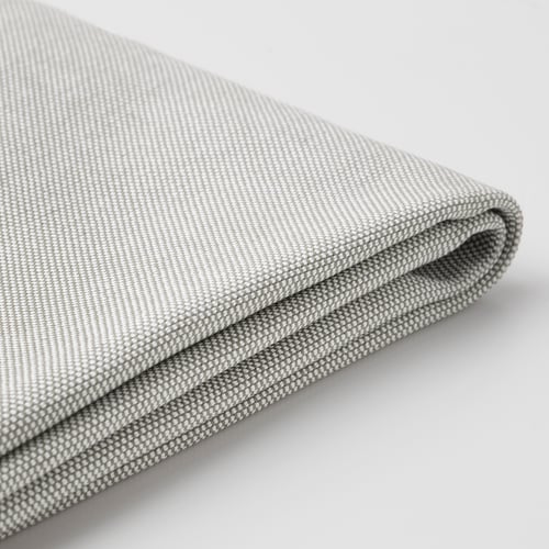 Volditud hall kangas lähivõte, mis näitab tekstuuri ja õmblusdetaile.