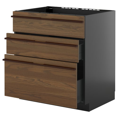 Sellel pildil on ikea METOD köögikapp, millel on tumepruunid puidust sahtlid ja klanitud mustad küljed.