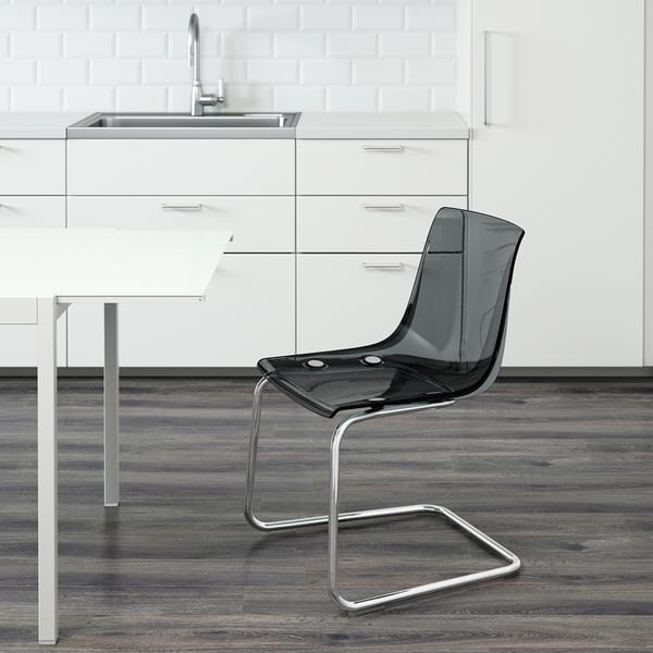 Kaasaegne köök elegantsete kappide ja kraanikausiga. Esiplaanil läbipaistev TOBIAS tool, millel on painduv iste ja seljatugi, mis on loodud sulanduma ümbritsevaga.