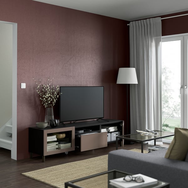 Modern living room with BESTÅ tv bench, flat screen, storage, media, remote-friendly, window with curtains, rug, coffee table.