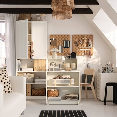 BILLY bookcase in white with mixed storage, baskets, boxes, and foldable table. Decorated, wicker light, striped rug, black stool.