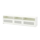 A white BRIMNES tv bench with glass doors and open shelves, ideal for organising tv accessories.