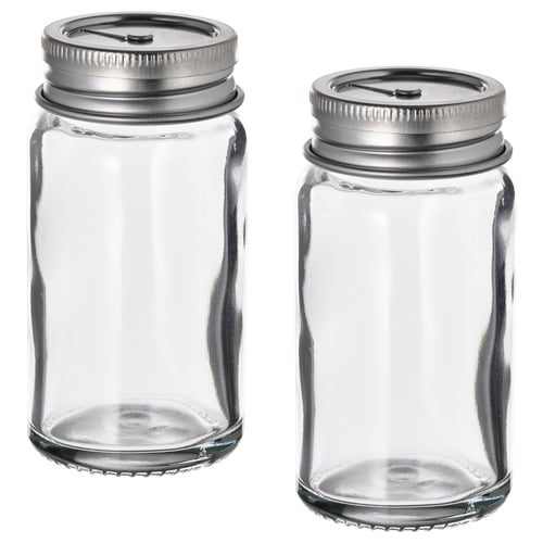 Two empty CITRONHAJ spice jars with silver lids, standing side by side, clear glass, cylindrical shape, simple design.