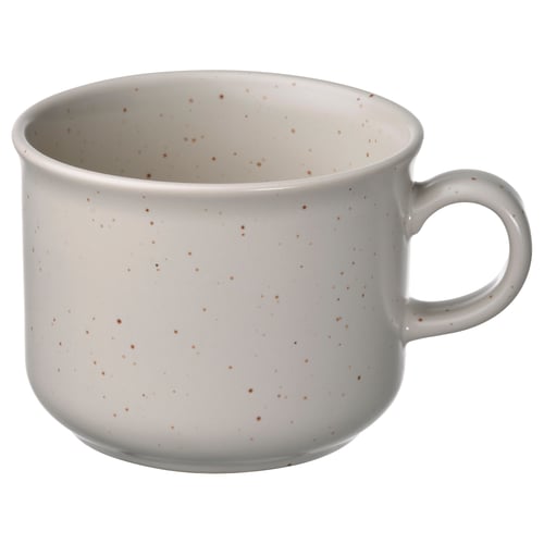 A white ceramic mug with brown speckles, a sturdy handle, and a round shape.