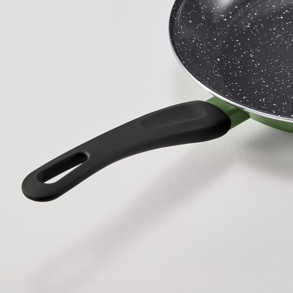 Close-up view of a non-stick frying pan with a black handle.