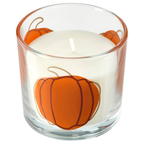 Glass candle holder, HÖSTAGILLE, white wax, orange pumpkin design, cylindrical shape.