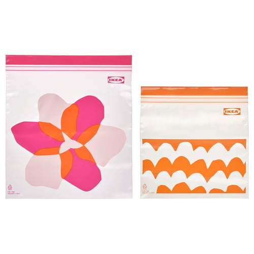 Two zip bags by IKEA, one bright pink and orange flower print, the other orange and white scallop print, displayed on white background.