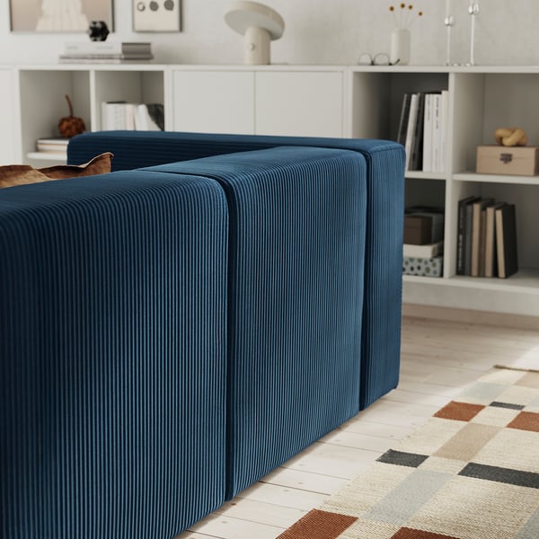Blue modular sofa with deep seats and under-seat storage. Suitable for relaxation and movie nights.