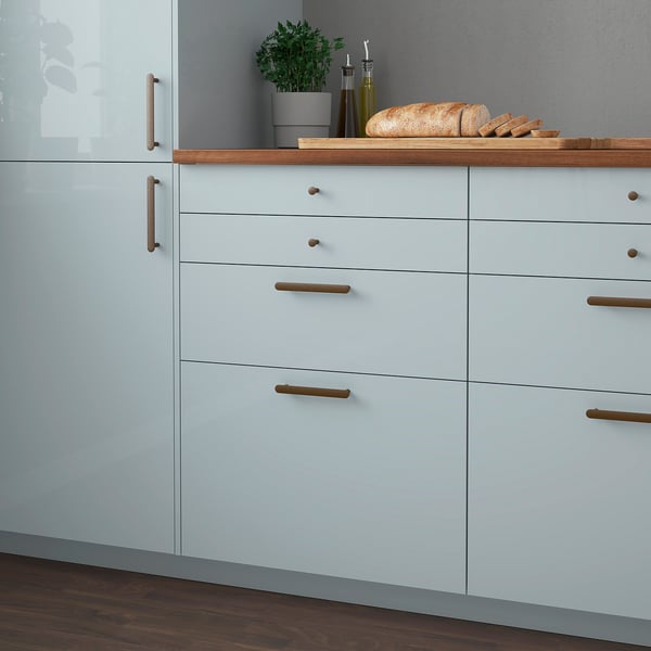 Modern kitchen with blue KALLARP drawers, wooden accents, and simple handles.