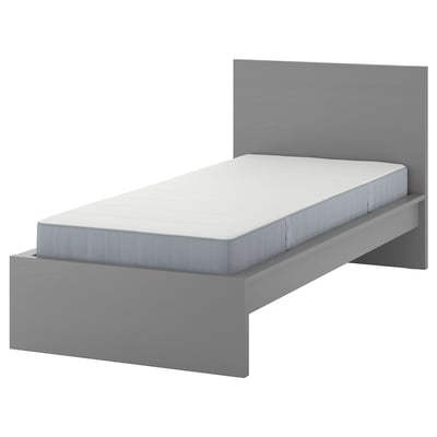 Modern, minimalist bed in grey with white mattress, no footboard.