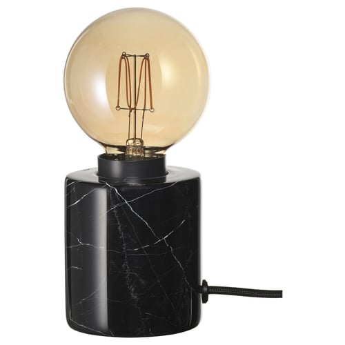 A MARKFROST lamp with a black marble base and an amber led bulb. The design is modern and sleek, providing warm ambient light.