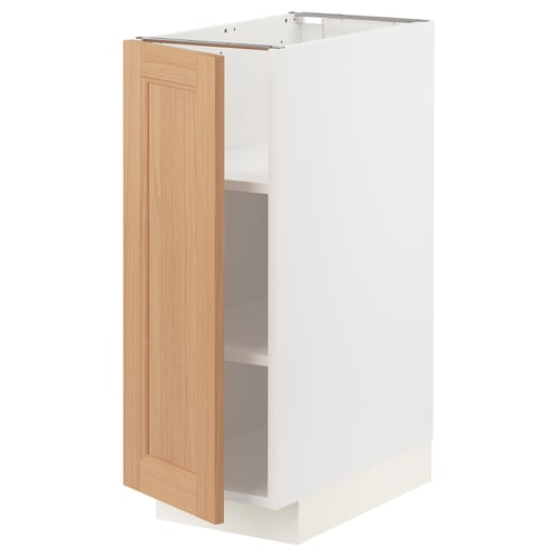 A white METOD kitchen cabinet with a light wood door. The cabinet has a modern design with one door open, revealing interior shelves.
