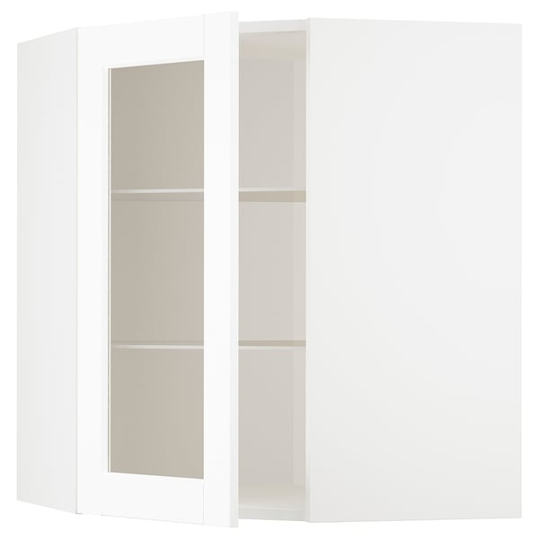 A white ikea METOD kitchen cabinet with glass doors and beige shelves.