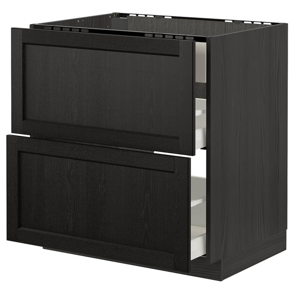 Black stained wooden kitchen cabinet with bevelled edges and open drawer.