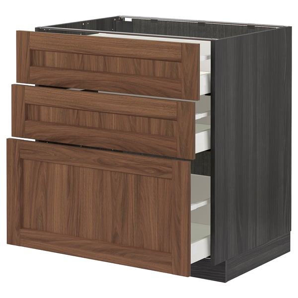 Wood-colored kitchen cabinet set with three drawers and a pullout shelf.