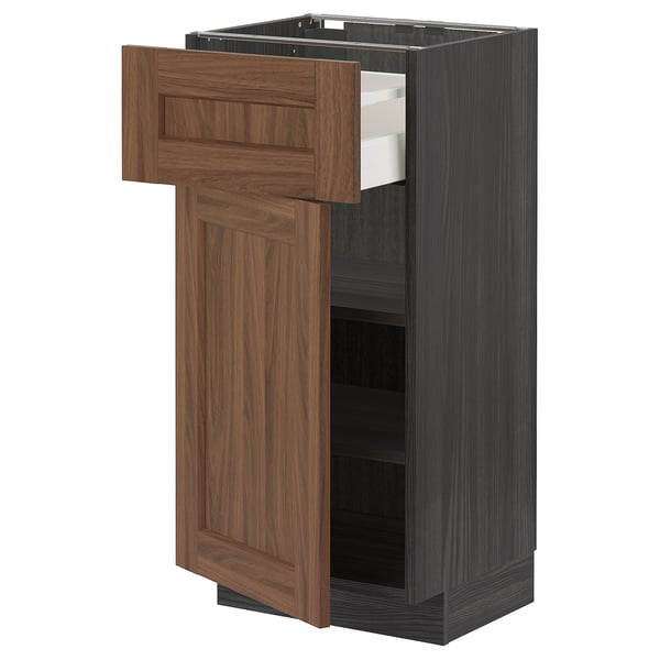 METOD kitchen unit in walnut, dark wood grain finish. A single open drawer and a cabinet door.