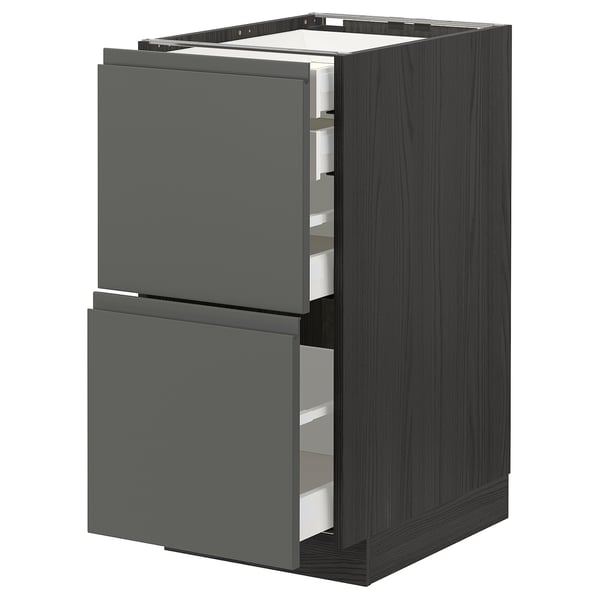 Modern kitchen unit with dark grey drawers, metallic runners, and sleek, minimalist design.