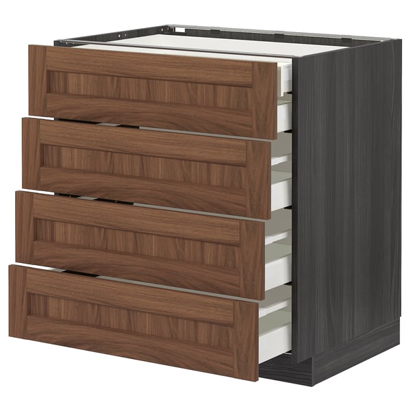 An IKEA METOD kitchen unit with four walnut-brown drawers and a grey base. The drawers have a horizontal grain pattern and metallic handles.