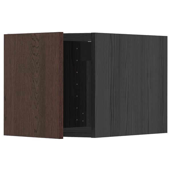 An open dark brown METOD kitchen cabinet with wooden edges and oak veneer on the door. It has hinges on the right side and a boxy rectangular shape.