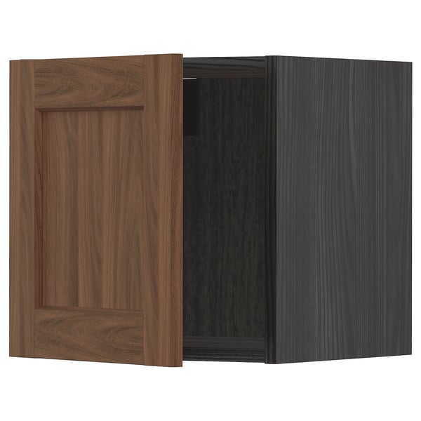 A walnut-colored METOD kitchen cabinet with a wooden door. It a square shape and classic design, combining dark wood grain texture.